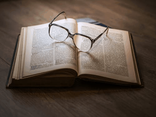 open book with glasses as a bookmark